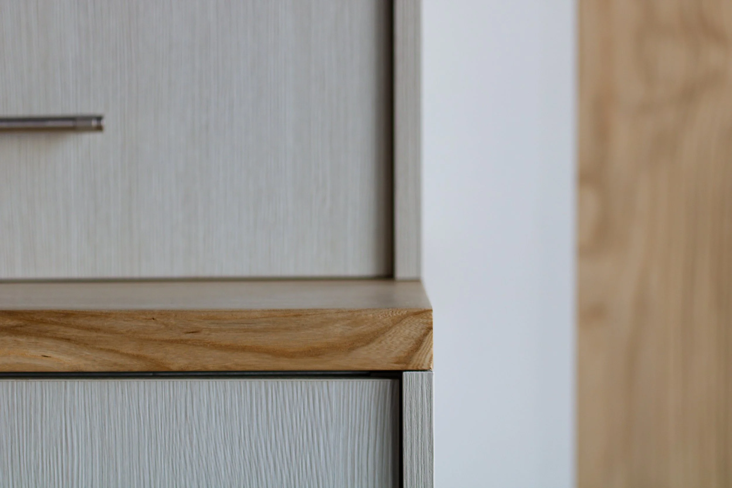 Close detail of custom cabinetry and wood countertop.