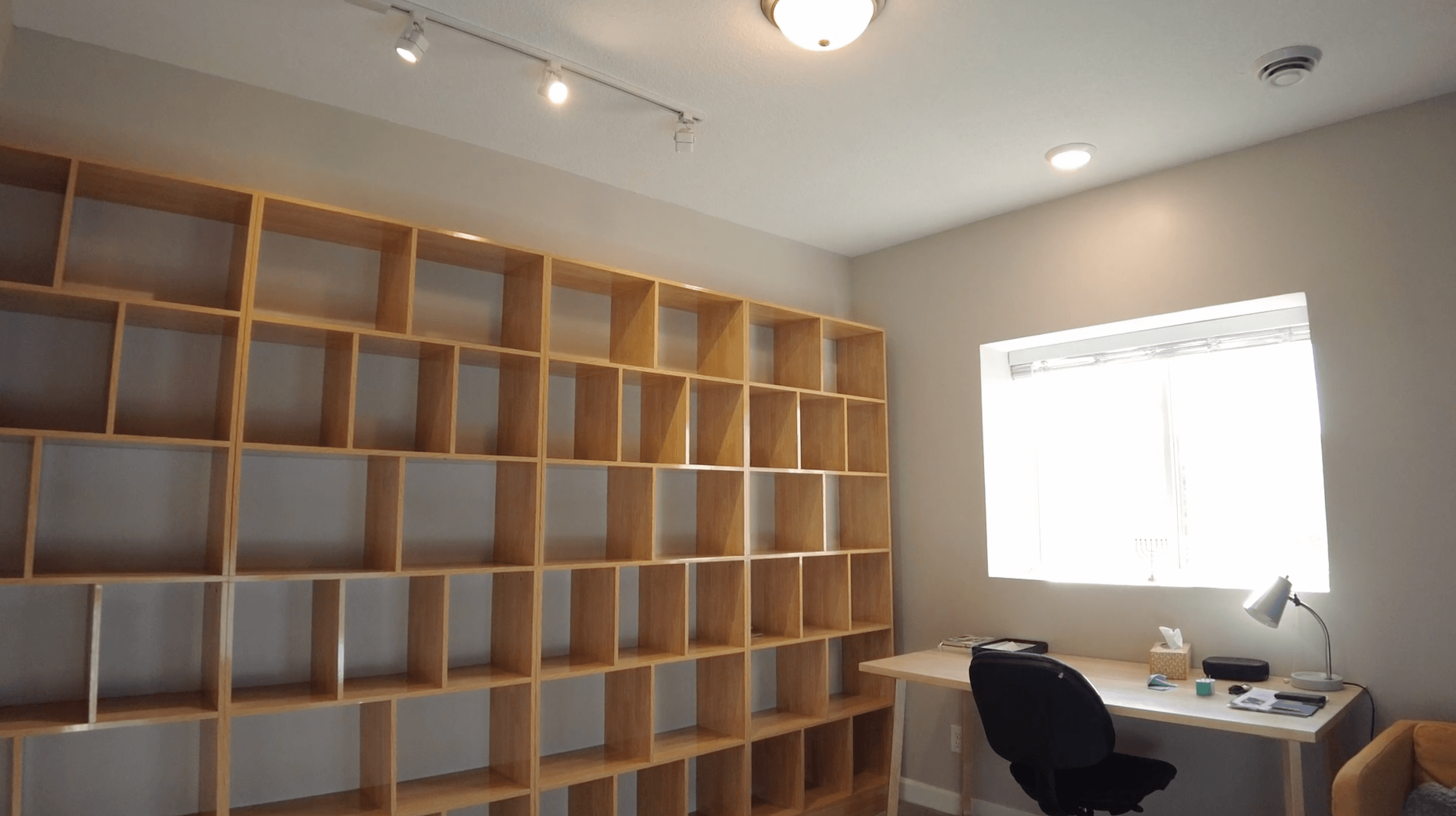 Built-in millwork detail in a finished basement — architectural shelving and warm wood tone.